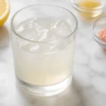 Salt and ice recipe for weight loss in a glass with lemon and ice cubes